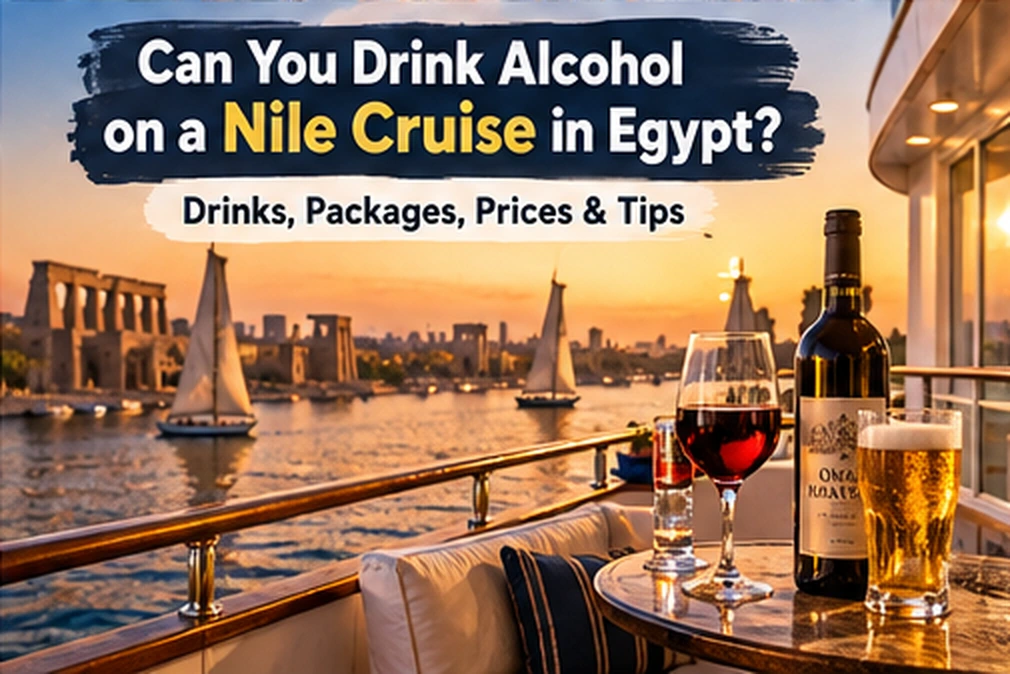 Glasses of wine and beer on a Nile cruise ship deck with sailing feluccas on the river